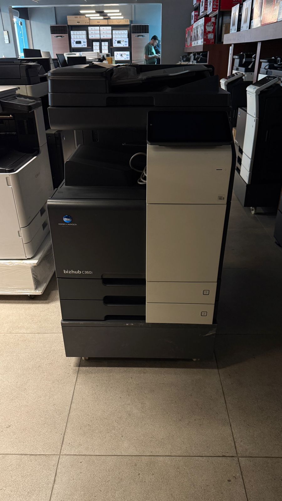 Large office printer in a room with other equipment